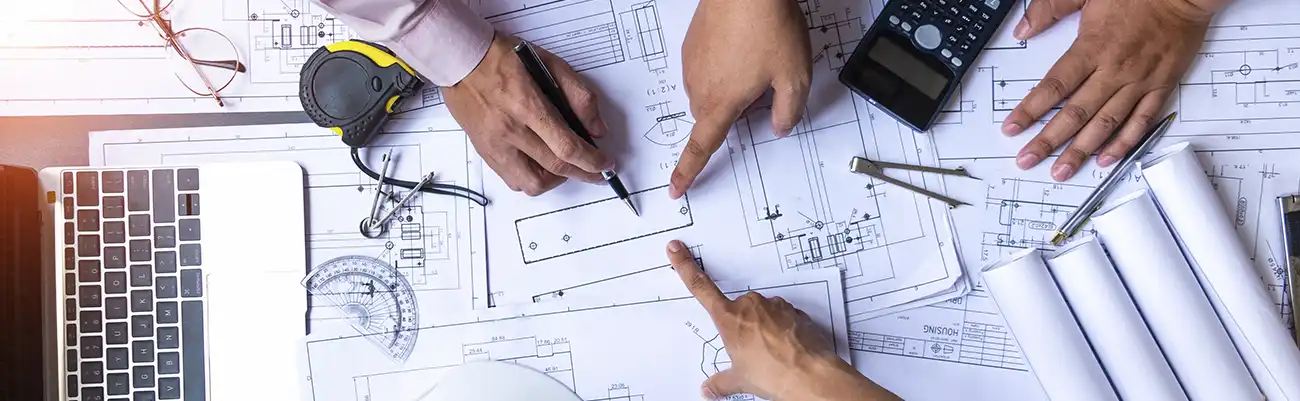 Blueprint meeting to avoid Six Costly Mistakes to Avoid When Choosing a Commercial Contractor