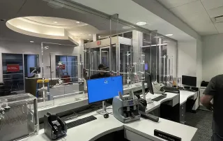 Updated teller workstations with protective glass partitions at an International Banking Company location.