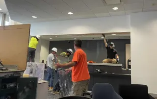 Construction crew performing teller counter demolition and renovations at an International Banking Company branch.