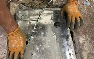 Electrical floor box installation during renovation at an International Banking Company branch.