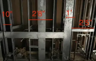 Exposed metal stud wall framing during construction at an International Banking Company renovation site.