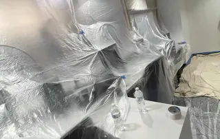 Teller work area protected from dust during bank renovation project.