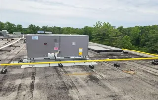 Installed rooftop HVAC unit on leveled curb during Omega Contracting & Consulting retail renovation project