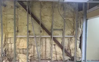 Framed wall with insulation – Structural reinforcement and framing work underway at Graze Craze Ellicott City.