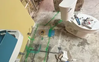 Restroom under construction – Omega Contracting preparing plumbing and layout adjustments during Graze Craze Ellicott City build-out.