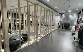 Omega Contracting lifting and stabilizing a failed ceiling corner inside an open retail store