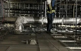 Omega Contracting team drilling and anchoring ceiling rods for structural stabilization project
