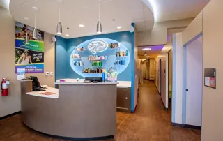 Completed reception area with branded display wall at Palm Beach Tan retail construction remodel by Omega Contracting & Consulting