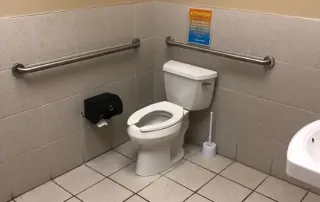 Restroom before renovation at Palm Beach Tan retail construction remodel by Omega Contracting & Consulting