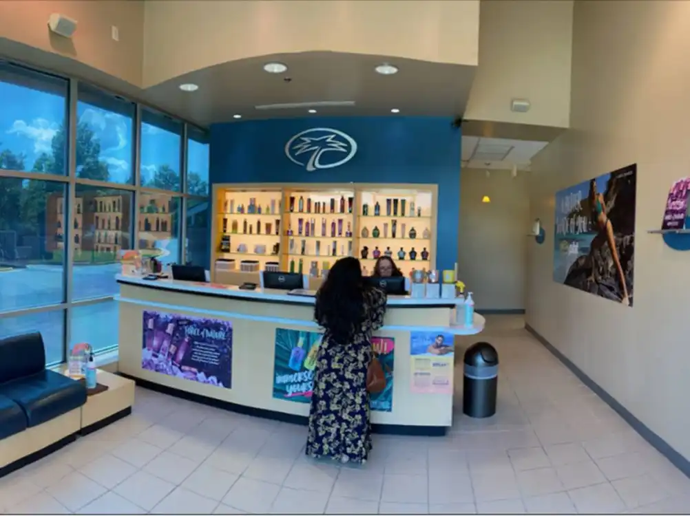 Completed reception area with branded display at Palm Beach Tan retail remodel by Omega Contracting & Consulting