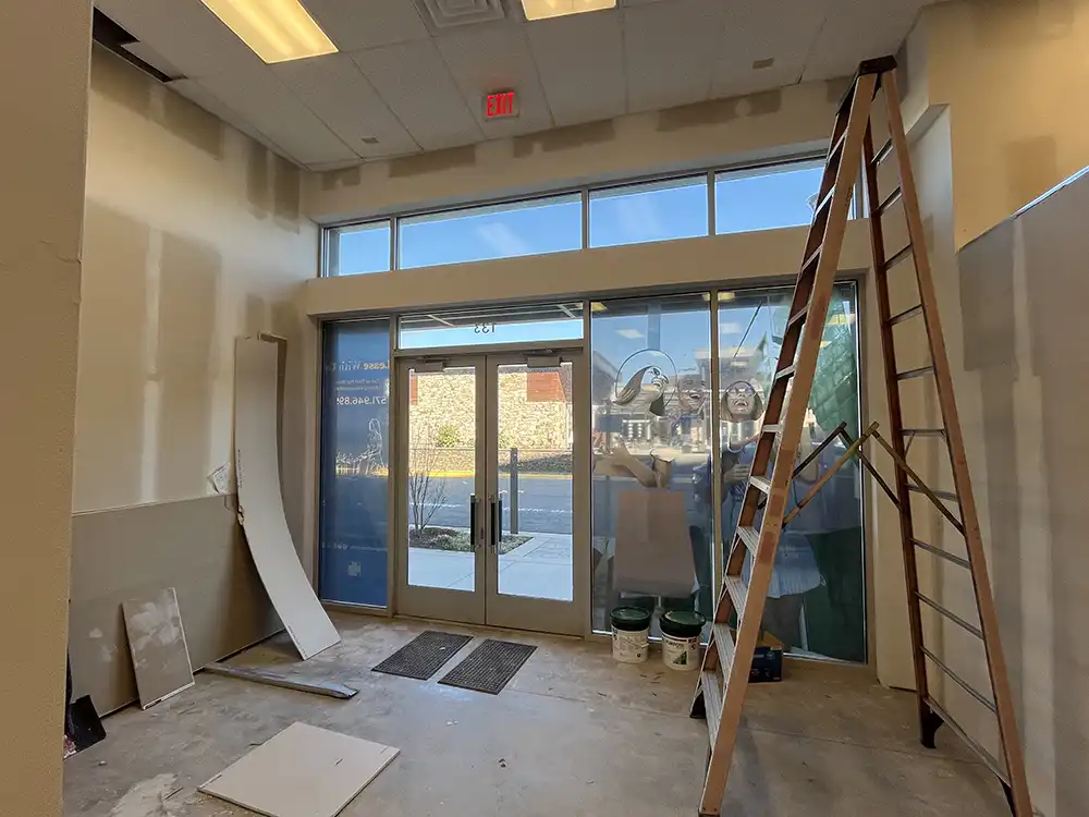 Entrance construction in progress at Palm Beach Tan retail remodel by Omega Contracting & Consulting