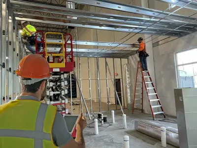 Omega Contracting site supervisor reviewing job site